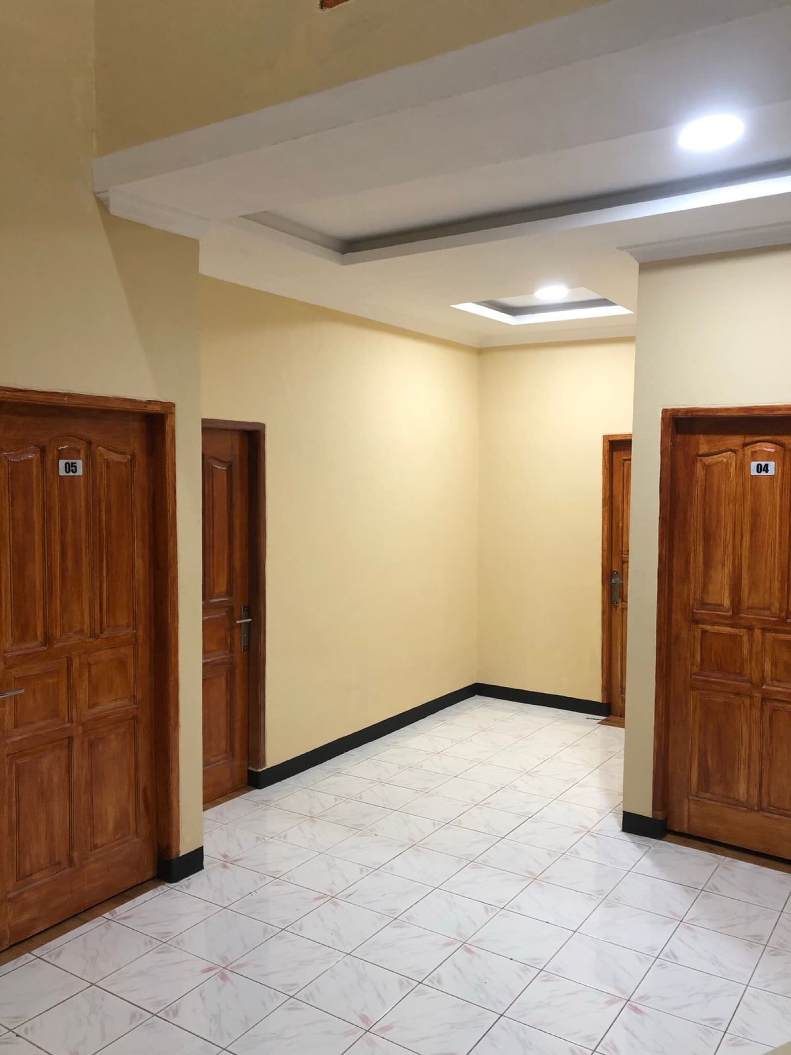 Koridor dalam kost dengan lantai keramik terang